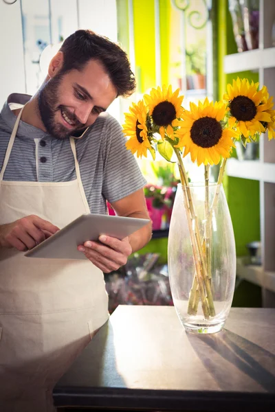 Male florist talking on mobile phone