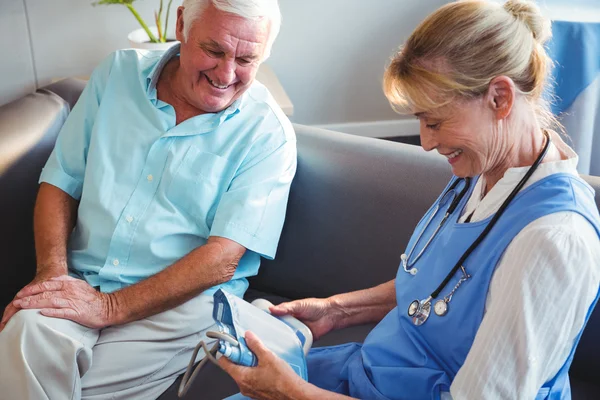 Nurse measuring the blood pressure of a senior man