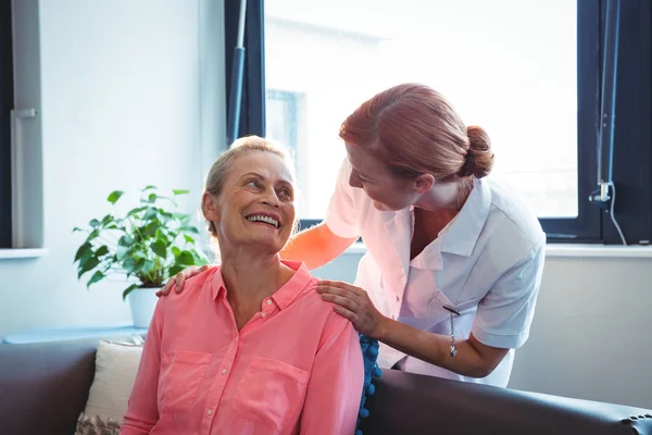 Nurse and senior woman looking at each other