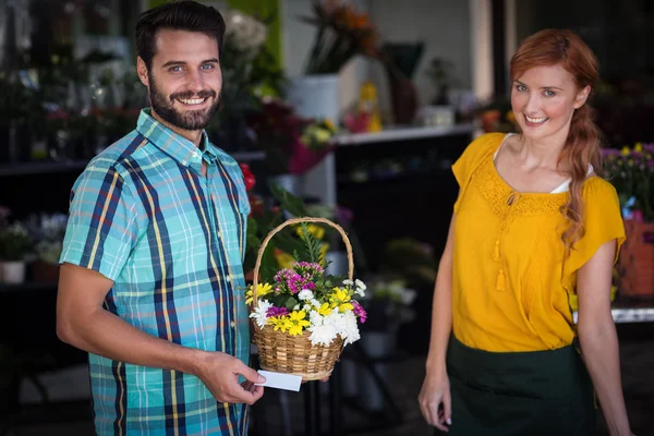 Female florist and customer with flower basket