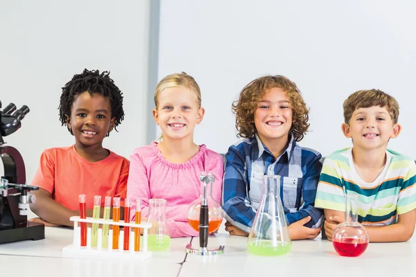 Portrait of kids doing a chemical experiment in laboratory