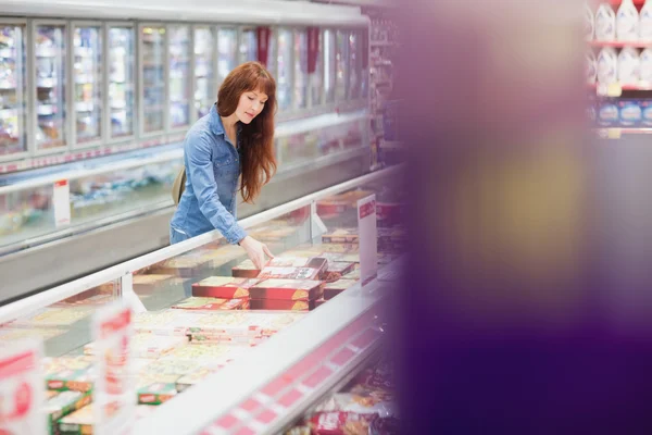 Customer picking a product in the frozen aisle