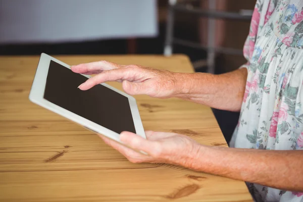 Old person touching a digital tablet