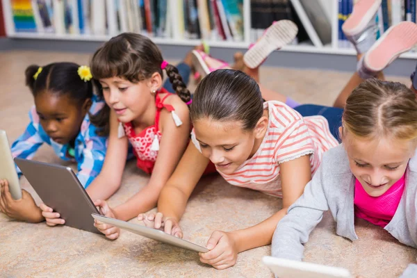 Kids using digital tablet in library