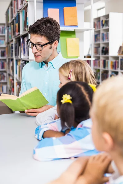 Teacher reading book in library