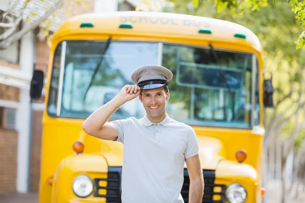 Bus driver smiling in front of bus