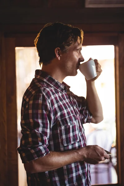 Man drinking coffee alone