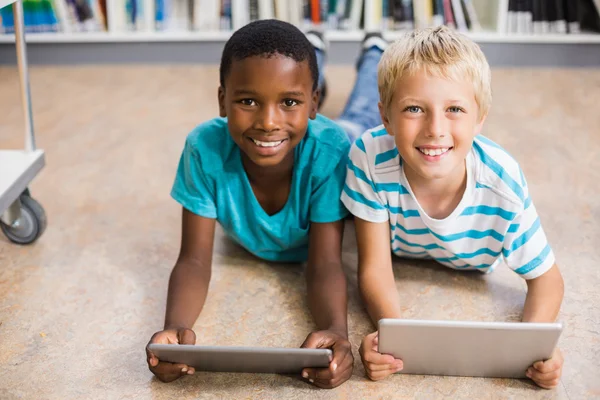 Kids using digital tablet in library