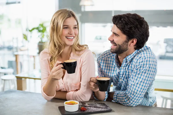 Happy couple having cup of coffee