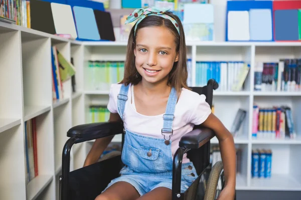 Disabled smiling schoolgirl in library