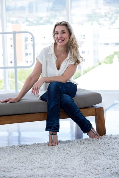 Smiling woman sitting on couch