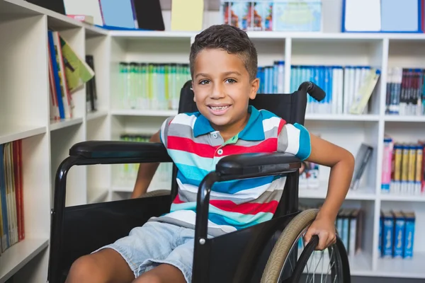 Disabled schoolboy in library