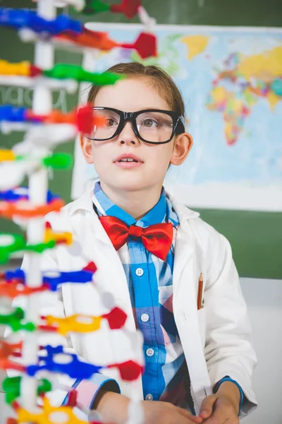 School girl assembling molecule model for science project in lab