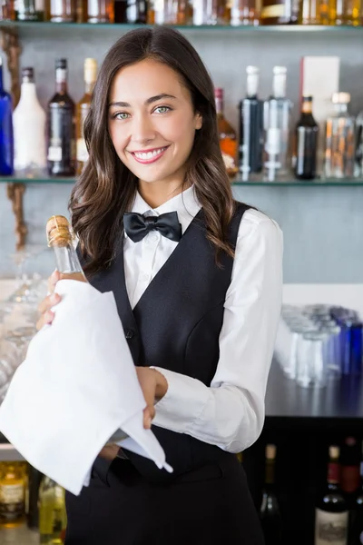 Beautiful waitress holding champagne bottle
