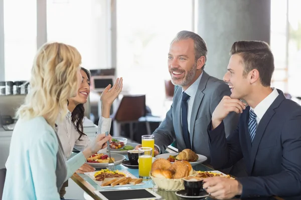 Business people having meal in restaurant