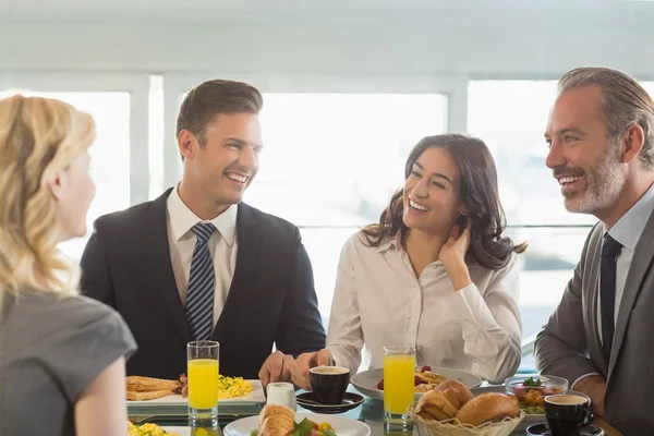 Business people having meal in restaurant