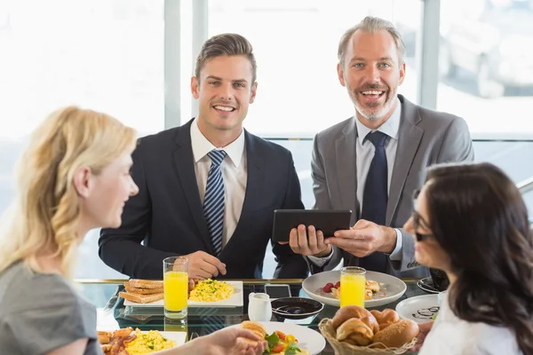 Business people having meal in restaurant