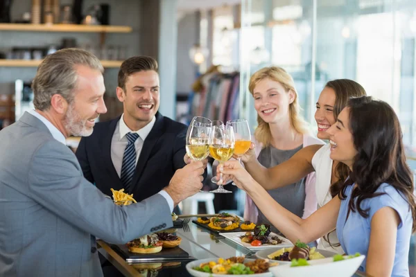 Happy business colleagues toasting beer glasses