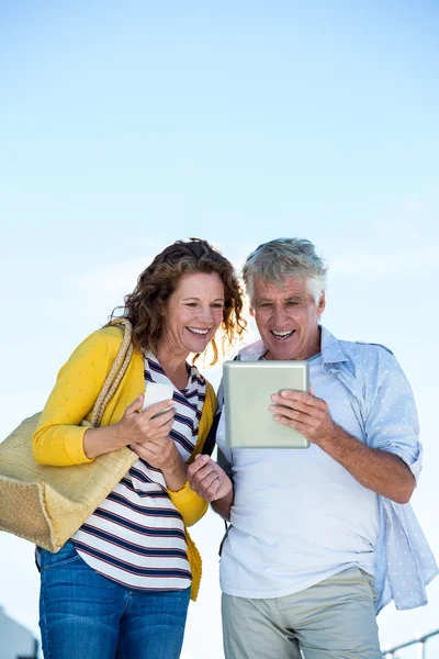 Couple using digital tablet