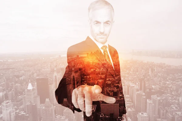 Composite image of businessman pointing