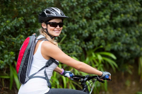 Woman cycling in countryside