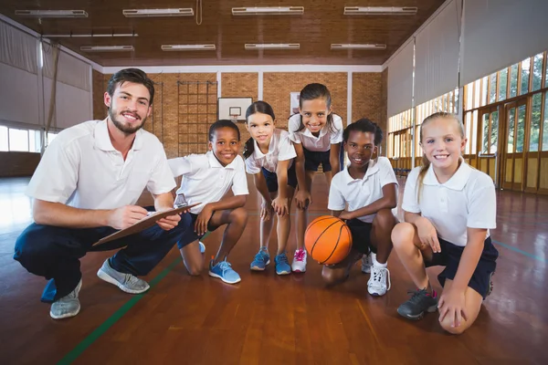 Portrait of sports teacher and school kids