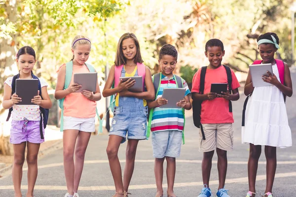 Group of school kids using digital tablet