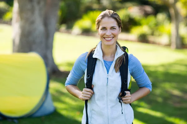 Portrait of female hiker standing with rucksack