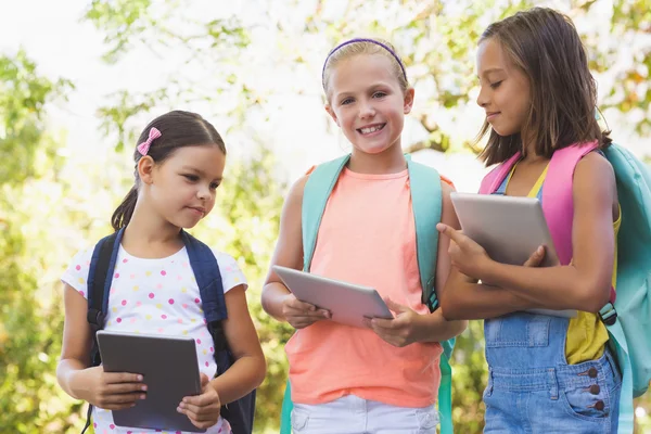 Portrait of school kids using digital tablet