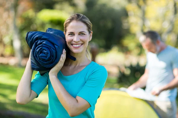 Female hiker holding travel bed