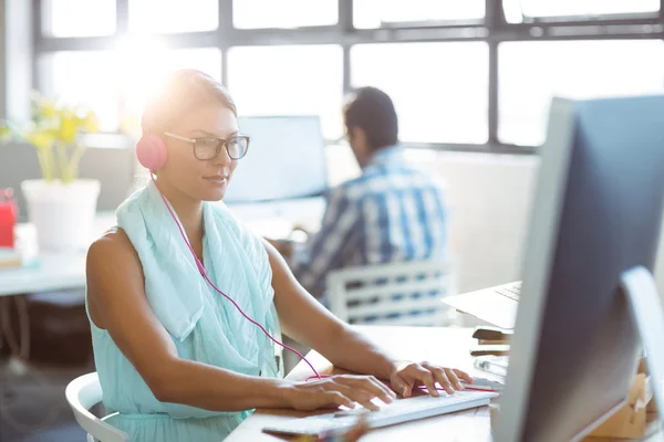 Business executive listening to music