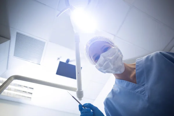 Dental assistant in surgical mask