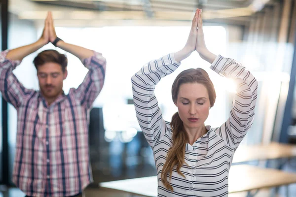 Business people performing yoga