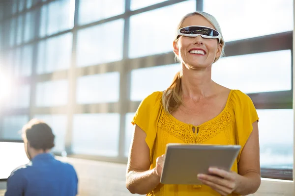 Female business executive in virtual reality video glasses using