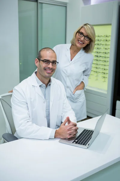 Smiling optometrists in ophthalmology clinic