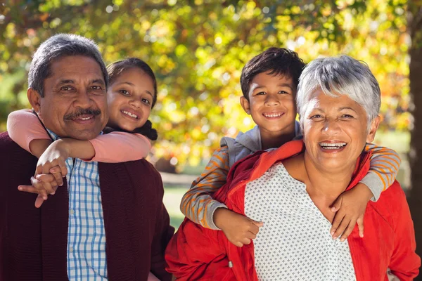 Grandparents piggybacking grandchildren