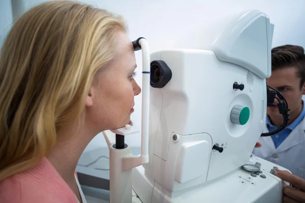 Female patient looking through coreometry