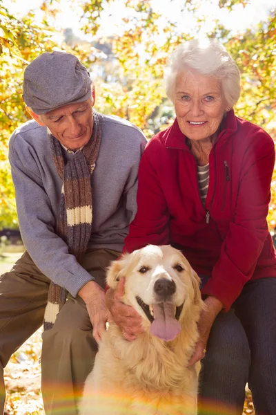 Elderly couple with their pet dog