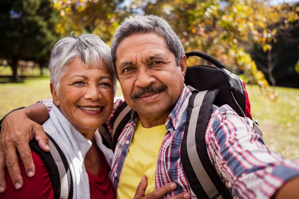 An elderly couple posing for a selfie