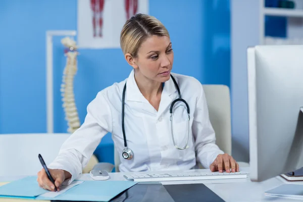 Physiotherapist writing a medical report