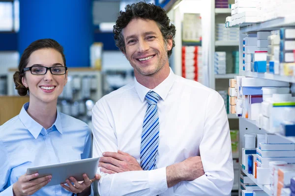 Pharmacists using tablet in pharmacy