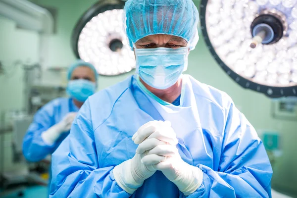 Surgeon praying in operation room