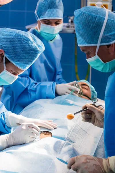 Surgeons performing operation in operation room