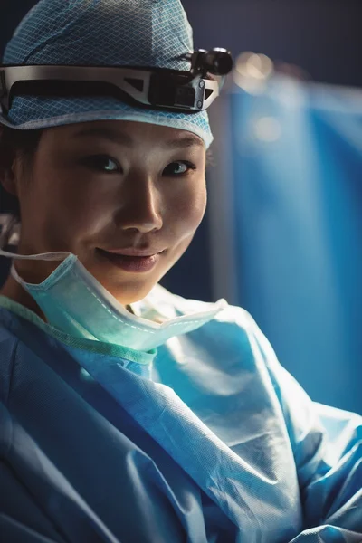 Smiling female surgeon in operation room