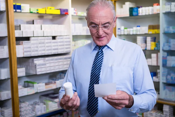 Pharmacist holding a prescription and medicine