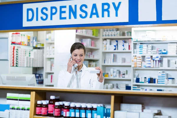 Pharmacist looking at medicine box