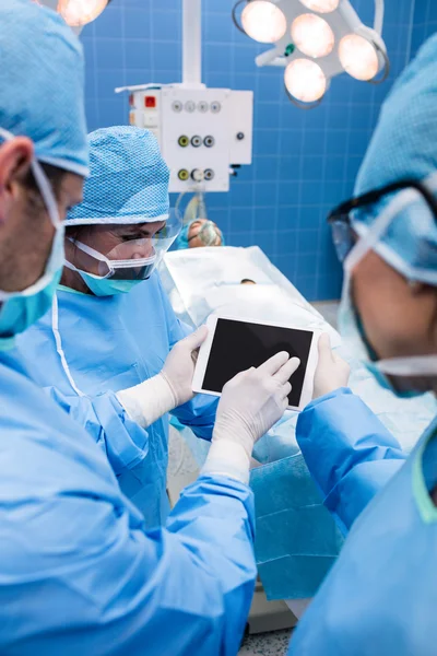 Surgeons using tablet