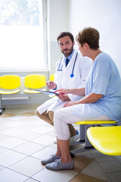 Doctor consulting patient in waiting room