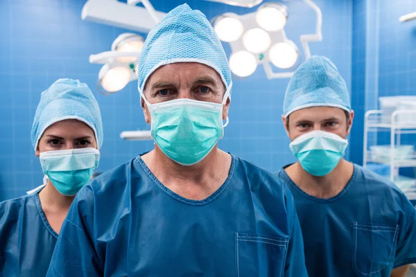 Surgeon and nurses in operation room