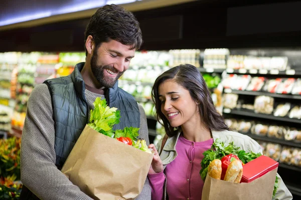 Couple shopping for vegetables in organic section